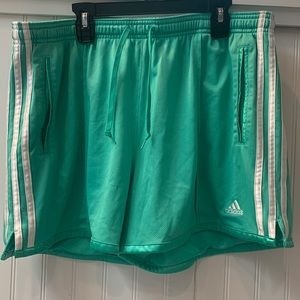 Two pair of Adidas three stripe shorts with pockets. Woman’s size XL. Red/Green